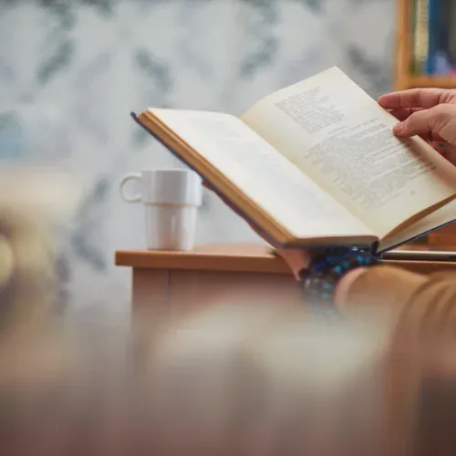 Un libro aperto accanto a una tazza, durante la lettura